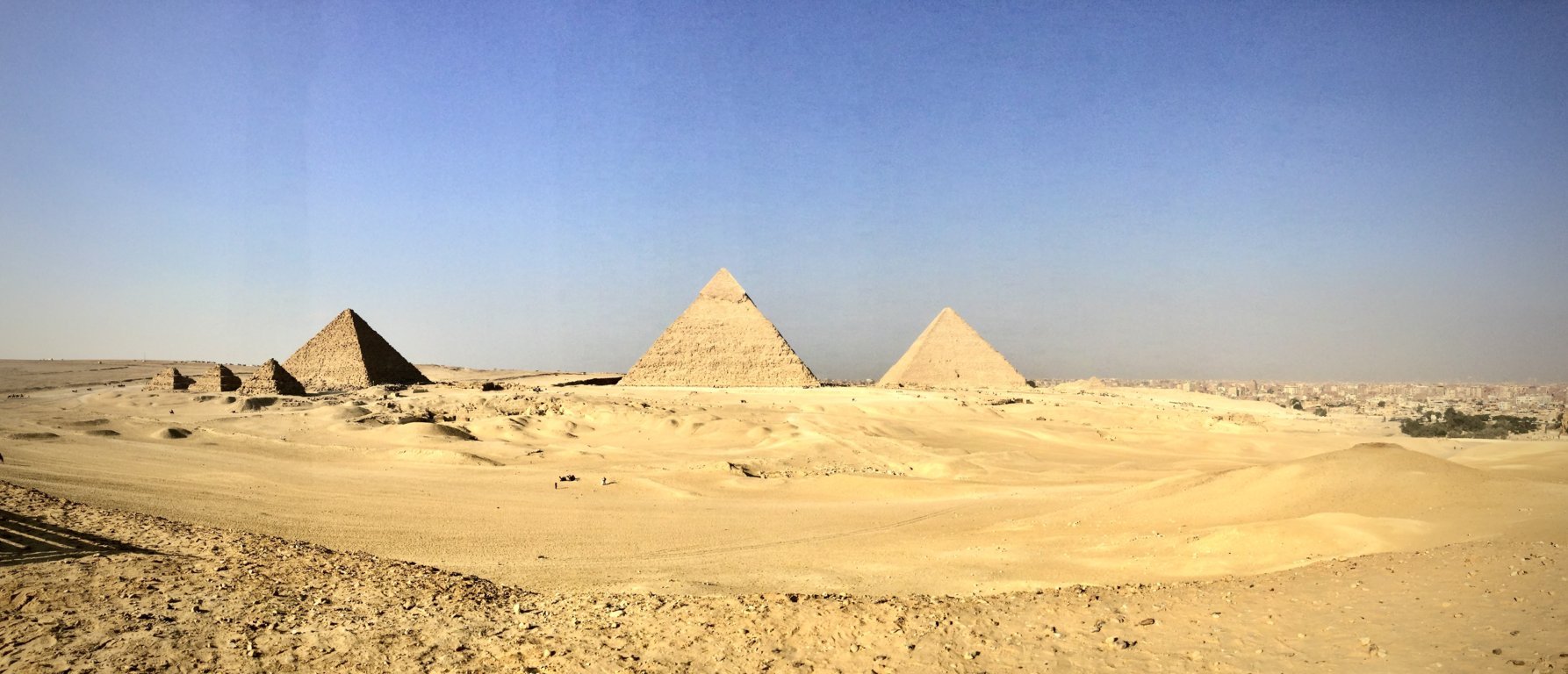 The pyramids rising from the golden sands of the Giza Plateau